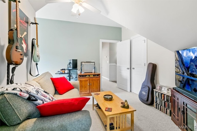 living area with a ceiling fan, vaulted ceiling, and light carpet
