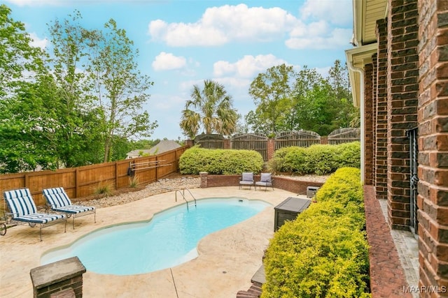 view of pool featuring a patio, a fenced in pool, and a fenced backyard
