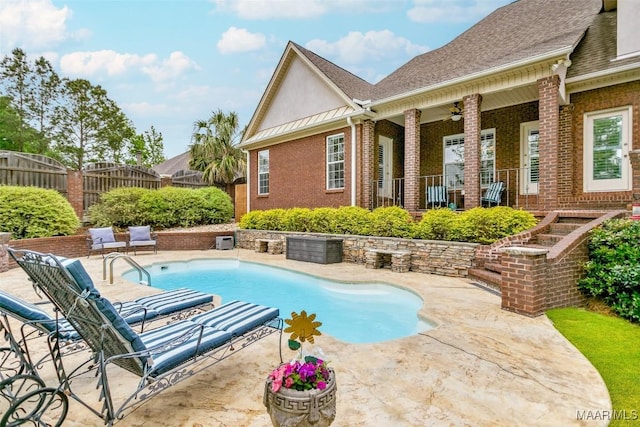 view of pool with a patio, ceiling fan, fence, and a fenced in pool