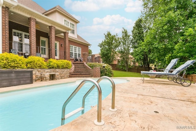 view of pool with stairs, a patio area, fence, and a fenced in pool