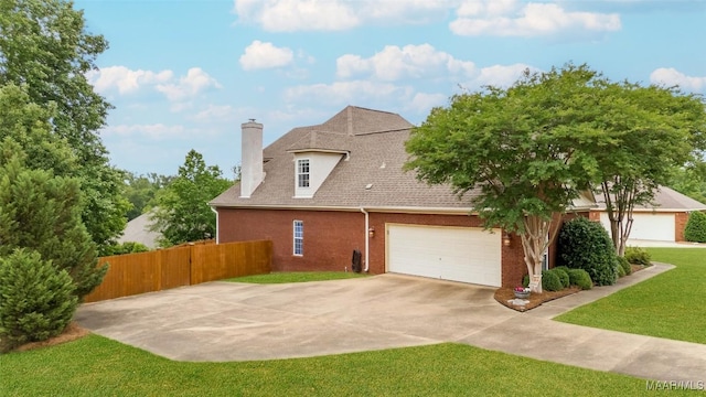 exterior space featuring a chimney, brick siding, fence, a yard, and a shingled roof