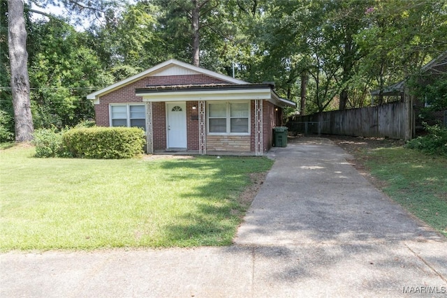 3374 Loch Haven Rd, Montgomery, AL 36109 - bungalow with fence, a front yard, driveway, and brick siding