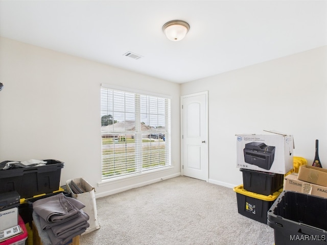 interior space featuring baseboards, carpet, and visible vents