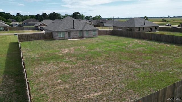 view of yard with a fenced backyard and a residential view