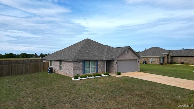 view of front of house with fence, a garage, a front yard, and brick siding