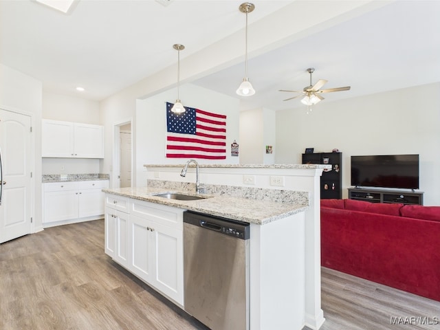 kitchen with decorative light fixtures, dishwasher, a sink, open floor plan, and light wood-style flooring