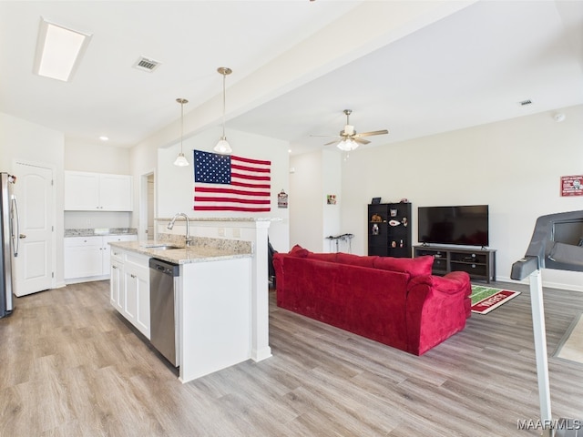 kitchen featuring visible vents, light wood-style floors, white cabinets, a sink, and appliances with stainless steel finishes