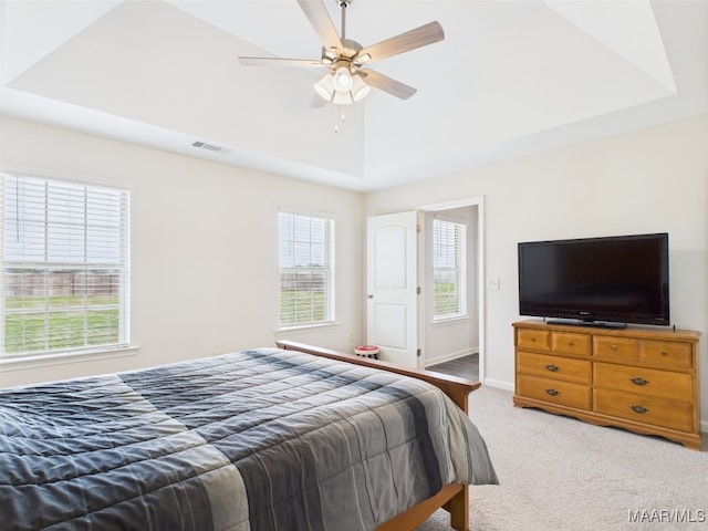 carpeted bedroom featuring visible vents, a ceiling fan, baseboards, and multiple windows