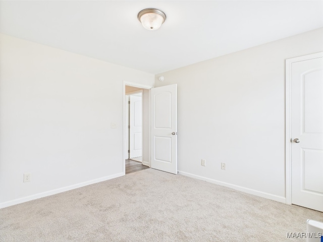 carpeted spare room with baseboards