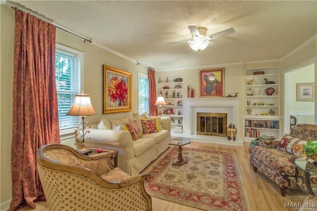 908 W Tuskeena St, Wetumpka, AL 36092 - living area featuring crown molding, a ceiling fan, a textured ceiling, and wood finished floors