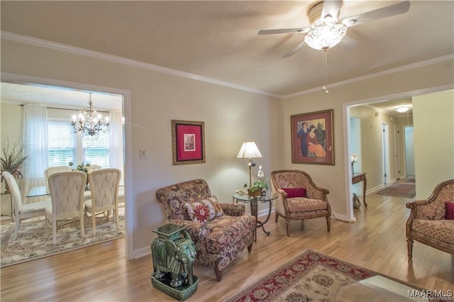 908 W Tuskeena St, Wetumpka, AL 36092 - living area featuring crown molding, wood finished floors, and ceiling fan with notable chandelier