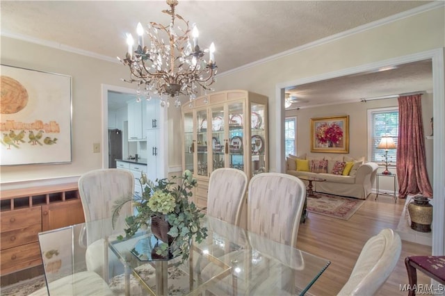 908 W Tuskeena St, Wetumpka, AL 36092 - dining area with crown molding, an inviting chandelier, and wood finished floors