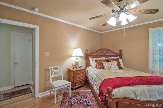 908 W Tuskeena St, Wetumpka, AL 36092 - bedroom with baseboards, ornamental molding, and wood finished floors