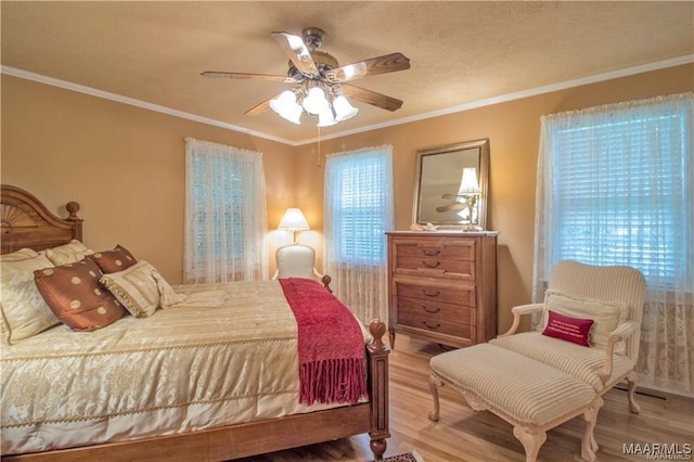908 W Tuskeena St, Wetumpka, AL 36092 - bedroom featuring ceiling fan, ornamental molding, and wood finished floors