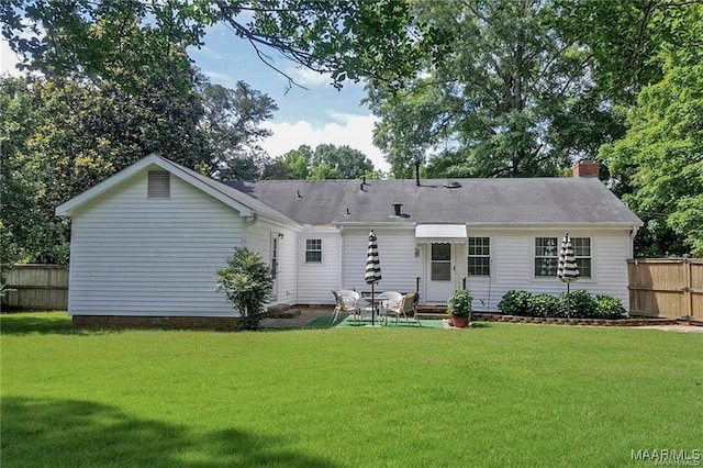 908 W Tuskeena St, Wetumpka, AL 36092 - rear view of property featuring a lawn, fence, and a chimney