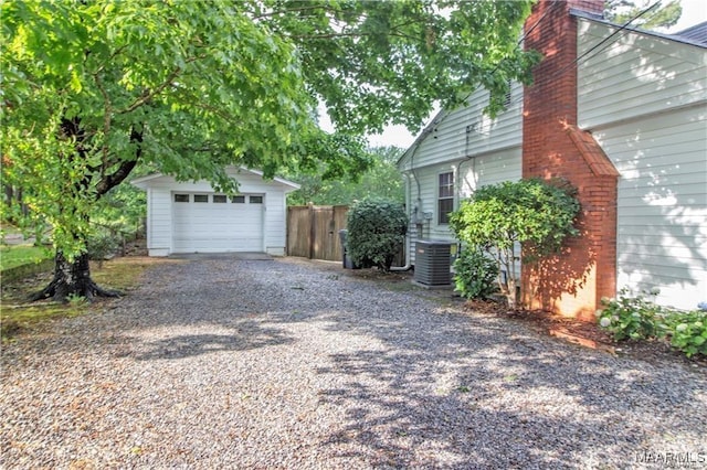 908 W Tuskeena St, Wetumpka, AL 36092 - view of property exterior featuring a chimney, central AC unit, fence, an outdoor structure, and gravel driveway