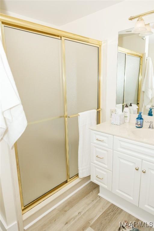 2755 Cherokee Trl, Tallassee, AL 36078 - full bathroom featuring vanity, wood finished floors, and a shower stall