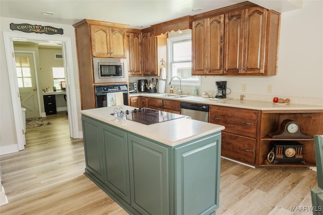 2755 Cherokee Trl, Tallassee, AL 36078 - kitchen featuring light countertops, a sink, black appliances, and light wood-style floors