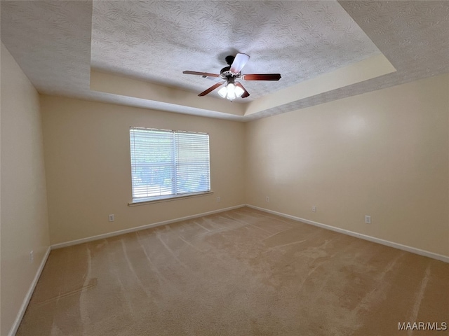 1672 Hawthorne Ln, Prattville, AL 36066 - empty room featuring baseboards, a textured ceiling, ceiling fan, and a tray ceiling
