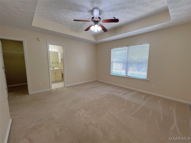 1672 Hawthorne Ln, Prattville, AL 36066 - unfurnished bedroom featuring a textured ceiling, baseboards, and a raised ceiling