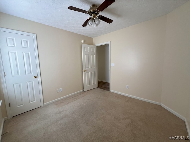 1672 Hawthorne Ln, Prattville, AL 36066 - unfurnished bedroom featuring baseboards, ceiling fan, carpet, and a textured ceiling