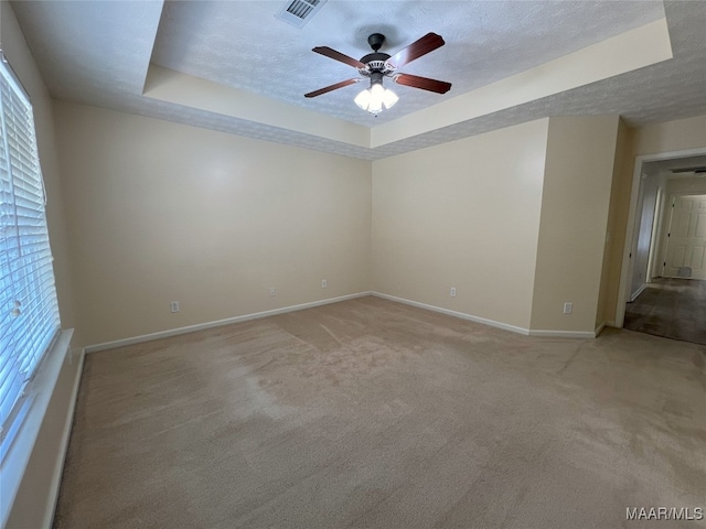 1672 Hawthorne Ln, Prattville, AL 36066 - empty room featuring baseboards, a ceiling fan, a tray ceiling, and visible vents