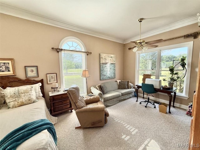 carpeted home office featuring crown molding, baseboards, and ceiling fan
