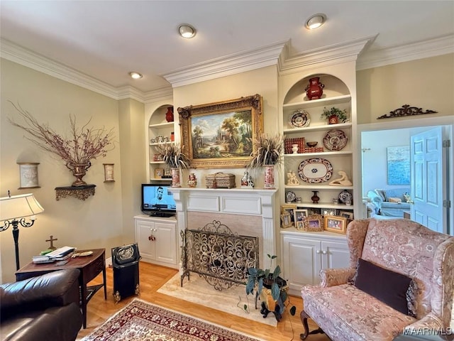 sitting room featuring recessed lighting, ornamental molding, and built in features