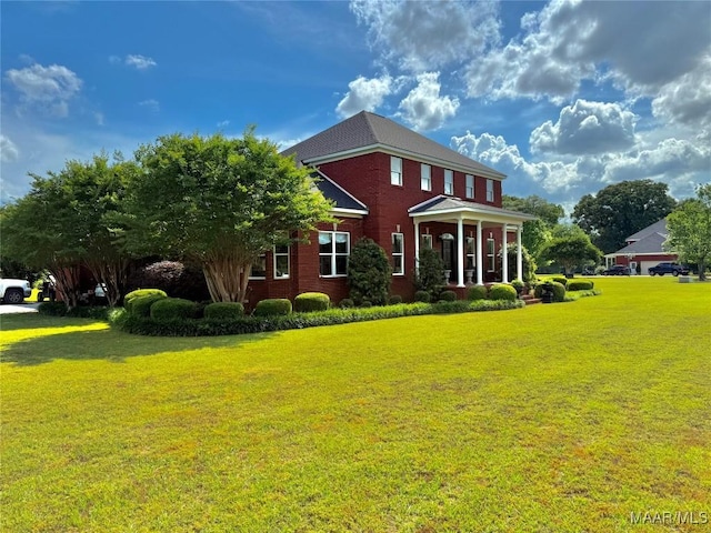 view of front of property featuring a front lawn and brick siding