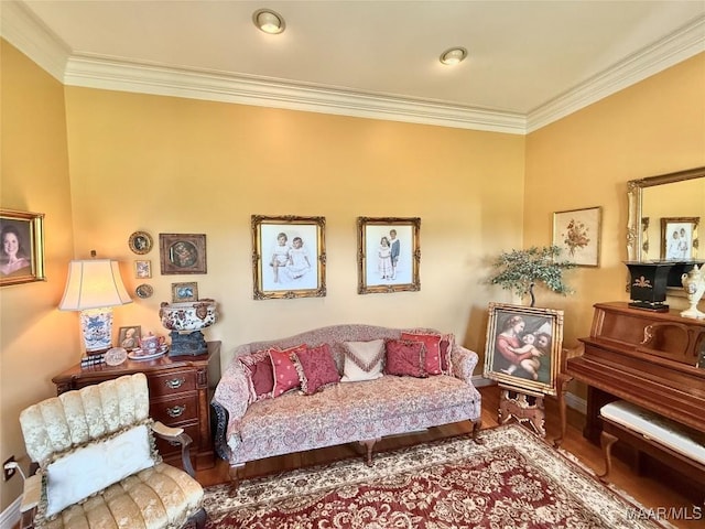 living area with baseboards, ornamental molding, and wood finished floors