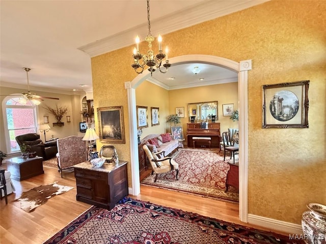 hallway with a notable chandelier, arched walkways, baseboards, wood finished floors, and ornamental molding