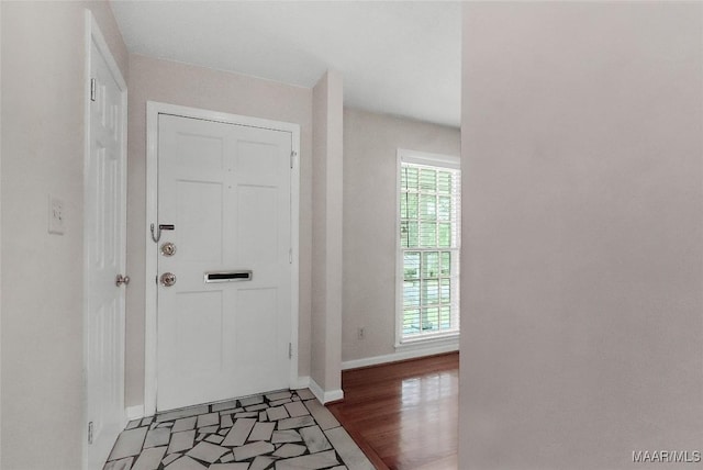 entrance foyer featuring baseboards and light wood-type flooring