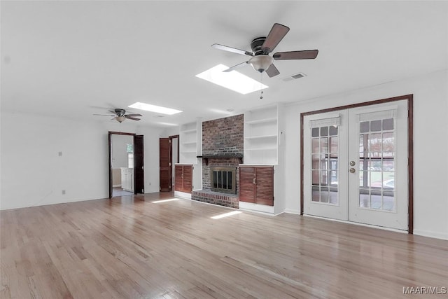 unfurnished living room featuring french doors, plenty of natural light, ceiling fan, and visible vents