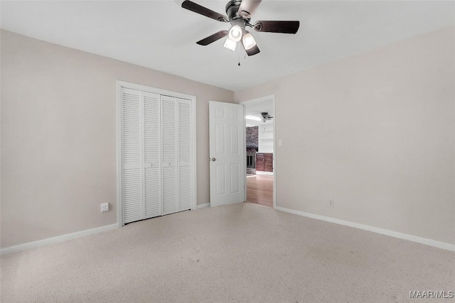 unfurnished bedroom featuring baseboards, ceiling fan, and a closet