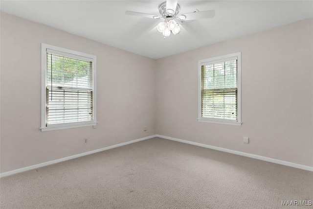 spare room with carpet floors, baseboards, plenty of natural light, and ceiling fan