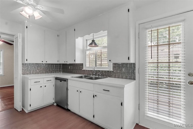 kitchen featuring stainless steel dishwasher, a ceiling fan, a sink, and light wood-type flooring