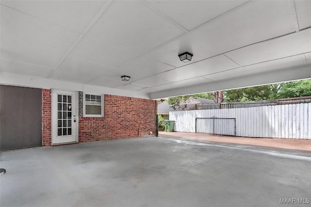 view of patio featuring fence and a carport