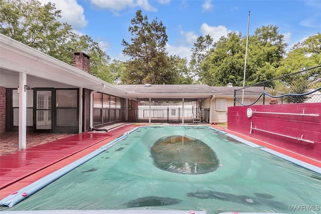 view of pool featuring fence