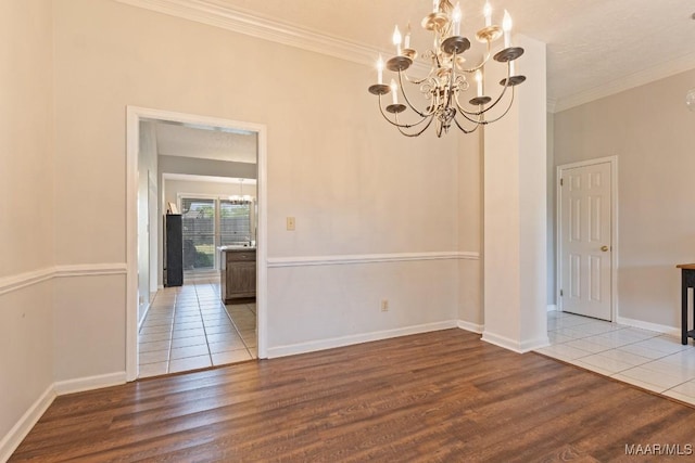 8800 Oak Meadow Ct, Montgomery, AL 36116 - unfurnished dining area featuring crown molding, baseboards, an inviting chandelier, and wood finished floors