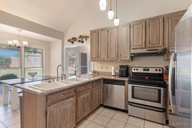 8800 Oak Meadow Ct, Montgomery, AL 36116 - kitchen featuring a peninsula, under cabinet range hood, a sink, light tile patterned floors, and stainless steel appliances
