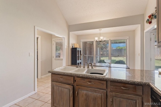 8800 Oak Meadow Ct, Montgomery, AL 36116 - kitchen with pendant lighting, a sink, light tile patterned floors, a notable chandelier, and vaulted ceiling