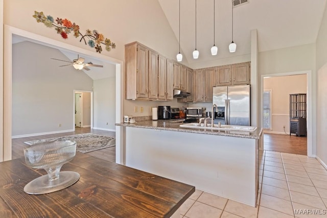 8800 Oak Meadow Ct, Montgomery, AL 36116 - kitchen featuring a ceiling fan, appliances with stainless steel finishes, light tile patterned floors, high vaulted ceiling, and under cabinet range hood
