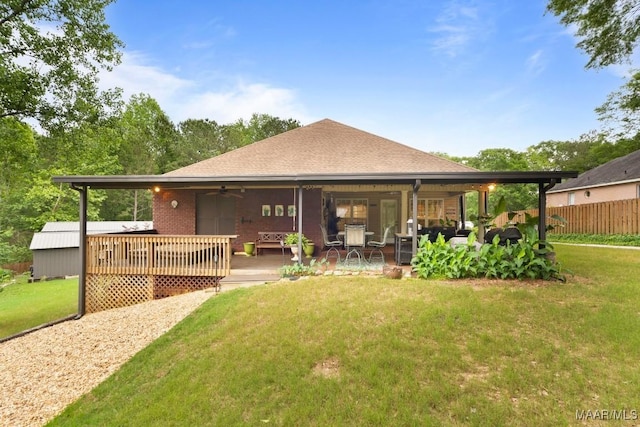 443 Fallon Ct, Deatsville, AL 36022 - back of property featuring a ceiling fan, roof with shingles, a deck, fence, and a yard