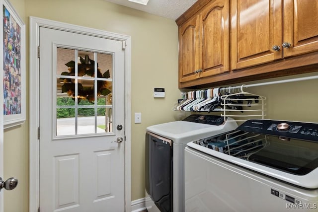 washroom with washing machine and dryer and cabinet space