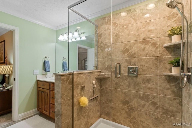 bathroom with vanity, ornamental molding, baseboards, and a stall shower