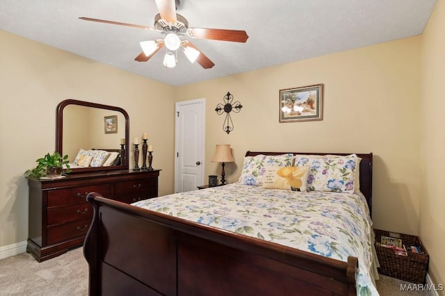 bedroom featuring baseboards, light carpet, and ceiling fan