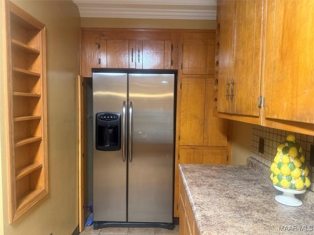3037 Willow Lane Dr, Montgomery, AL 36109 - kitchen featuring brown cabinetry, decorative backsplash, crown molding, stainless steel refrigerator with ice dispenser, and light countertops