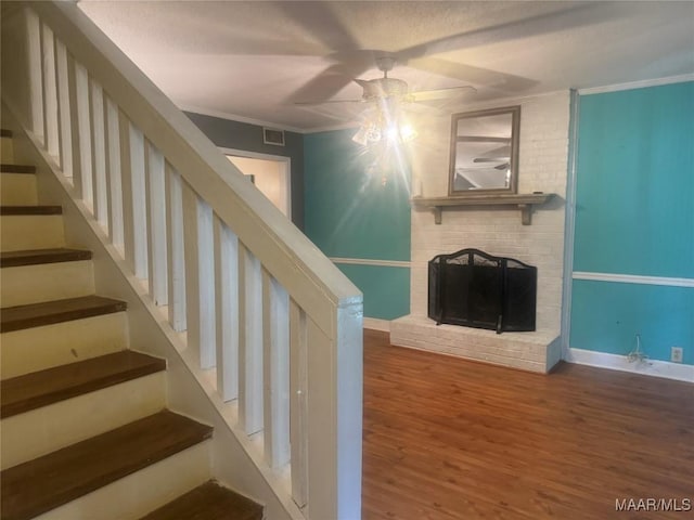 3037 Willow Lane Dr, Montgomery, AL 36109 - stairs with a ceiling fan, visible vents, a fireplace, wood finished floors, and ornamental molding