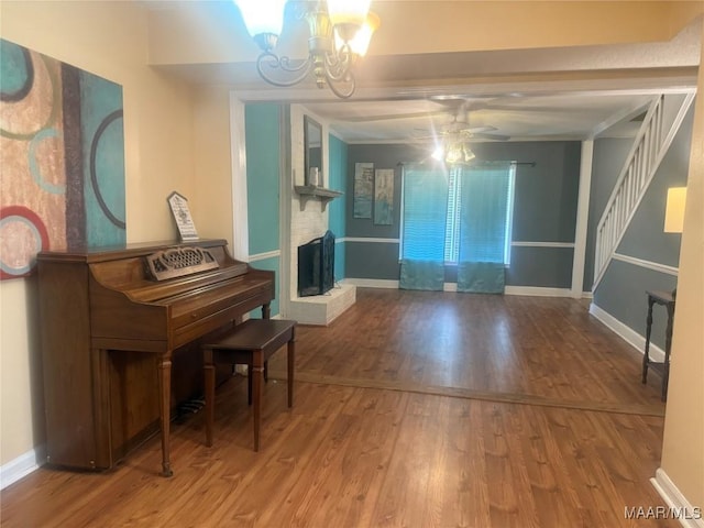 3037 Willow Lane Dr, Montgomery, AL 36109 - interior space featuring baseboards, ceiling fan with notable chandelier, wood finished floors, and a fireplace