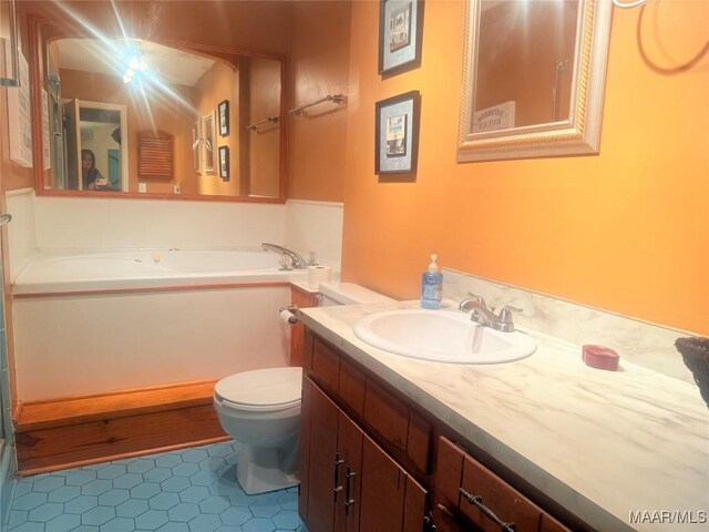3037 Willow Lane Dr, Montgomery, AL 36109 - full bath with a garden tub, tile patterned floors, toilet, and vanity